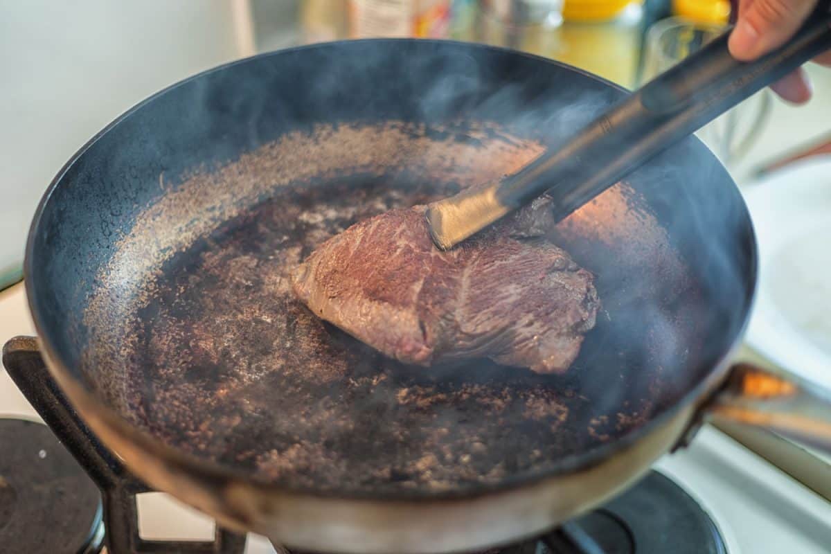 在滚烫的平底锅上煮一块美味的牛排