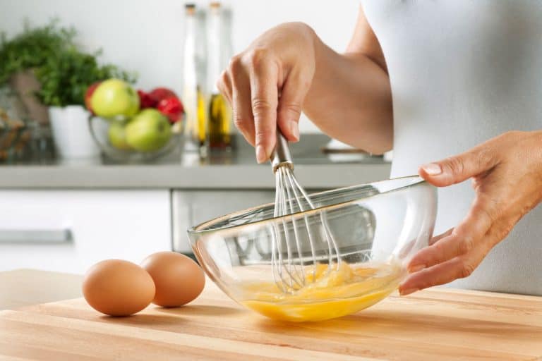 一个女人在家里的厨房里准备食物，打鸡蛋，你应该打鸡蛋吗?bd手机下载你需要知道的秘密!］