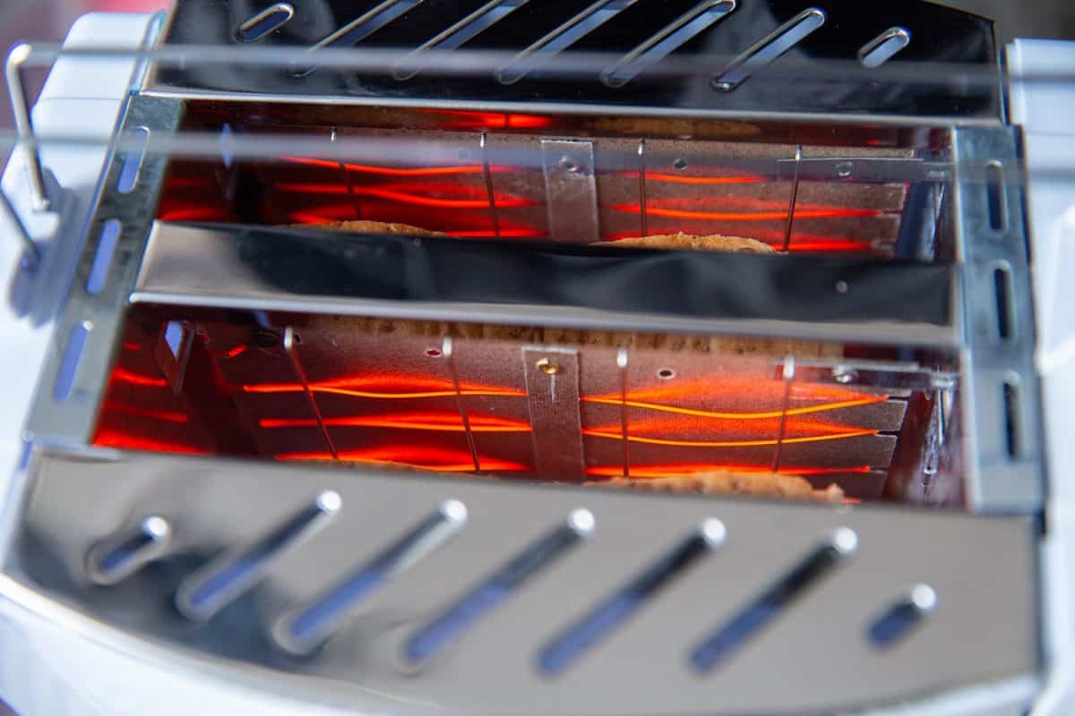 特写镜头里面包烤箱加热元件热灯丝发光的红色