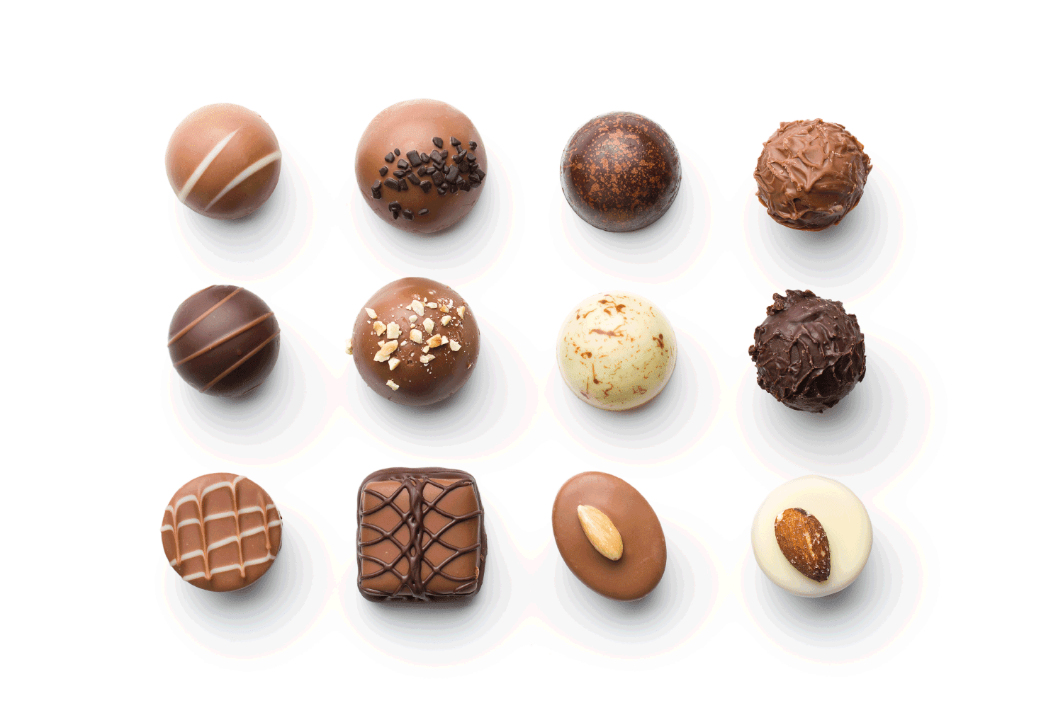顶视图的各种巧克力果仁糖在白色背景”width=
