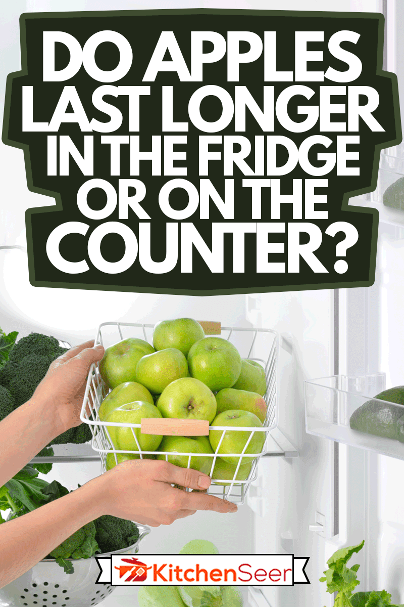 女性的手和篮子里有新鲜的苹果在冰箱里，苹果在冰箱里还是在柜台上更久?