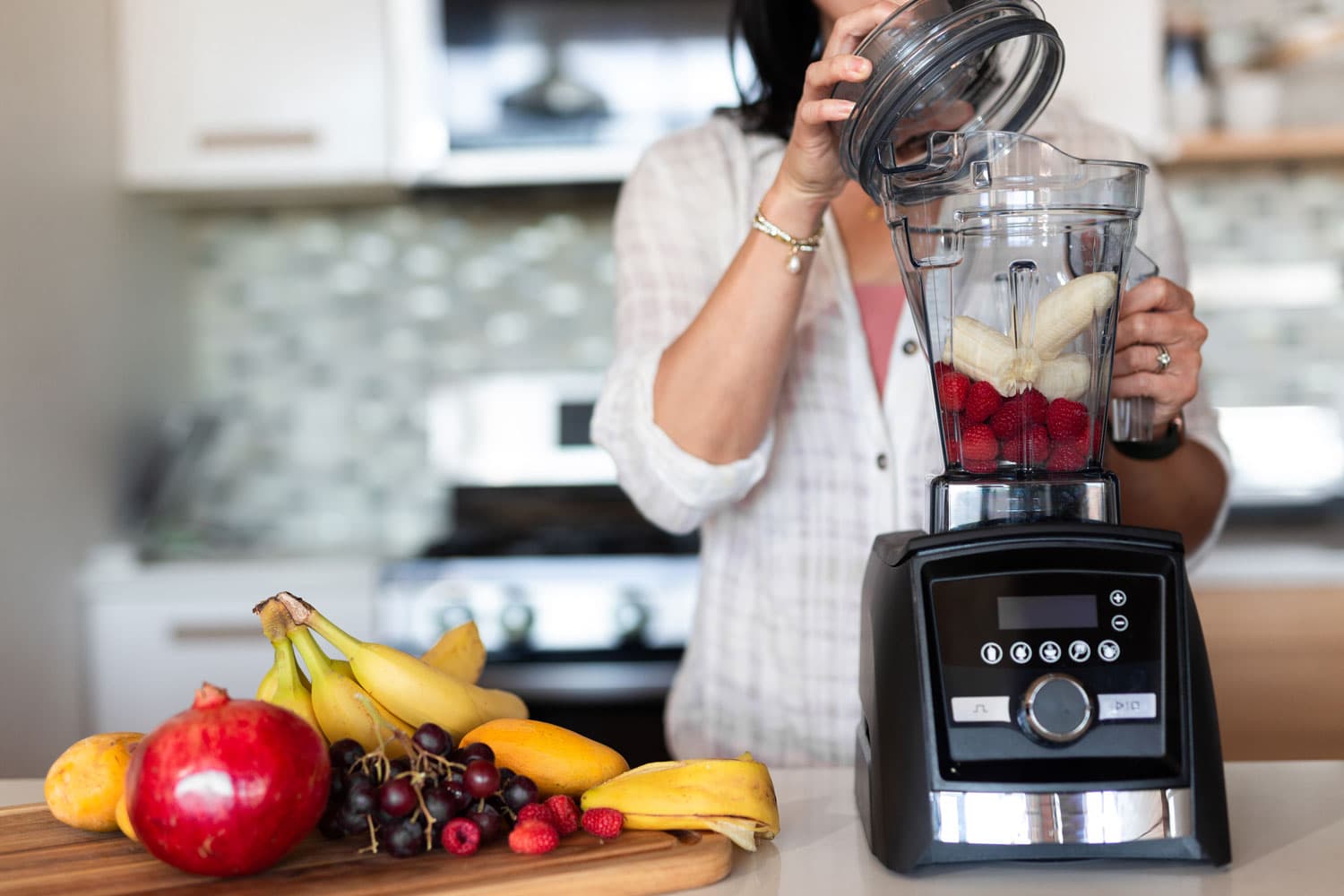 女人在厨房里制作奶昔使用Vitamix搅拌器bd手机下载