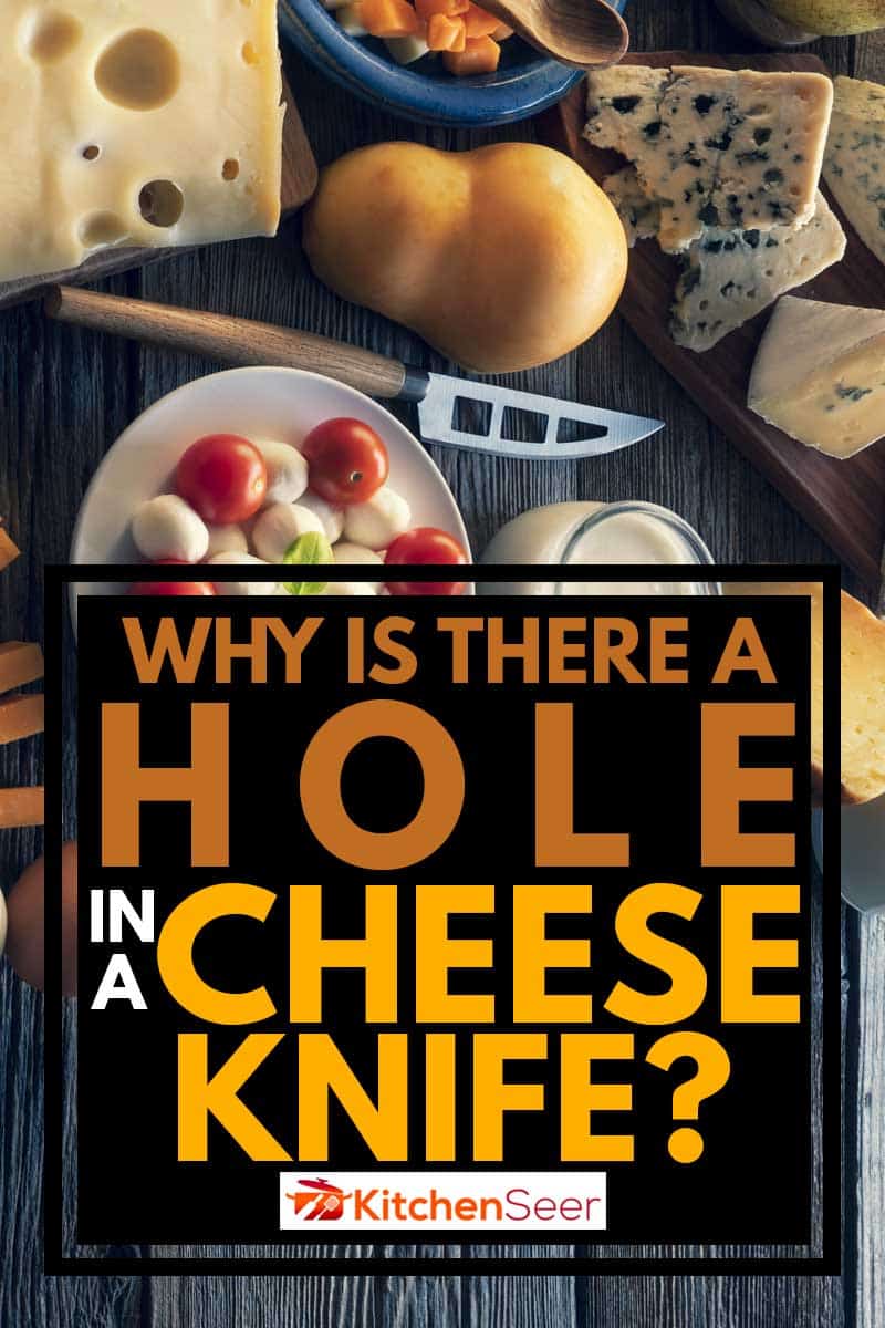 奶酪板上有许多不同的奶酪和乳制品，桌子上有奶酪刀，为什么奶酪刀上有一个洞?
