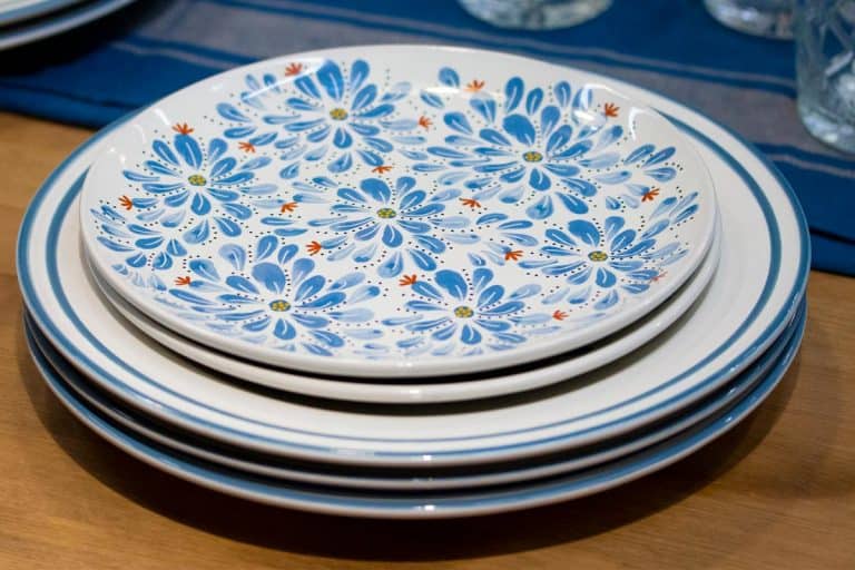 一堆蓝色盘子用鲜花放在桌上,Corelle菜可以在空气炸锅或烤箱吗?