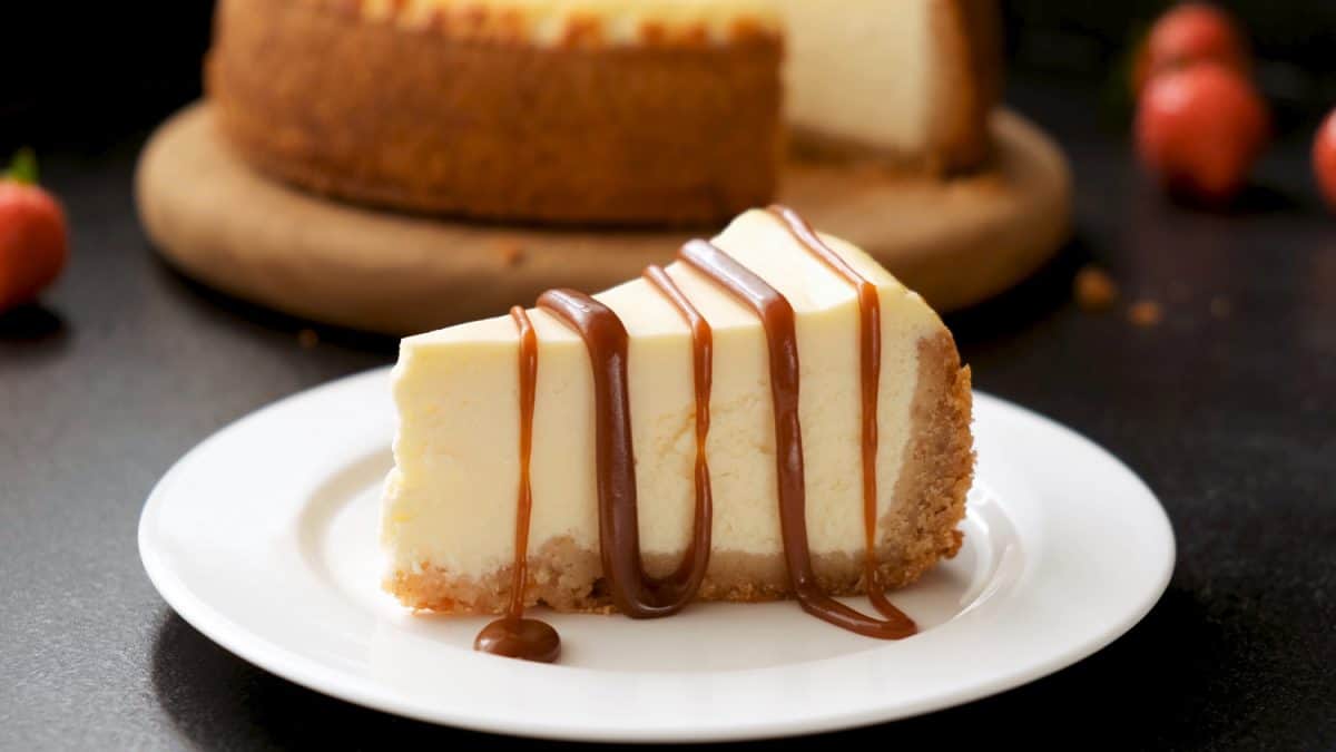 Cheesecake with caramel sauce on black background. Tasty homemade caramel cheesecake