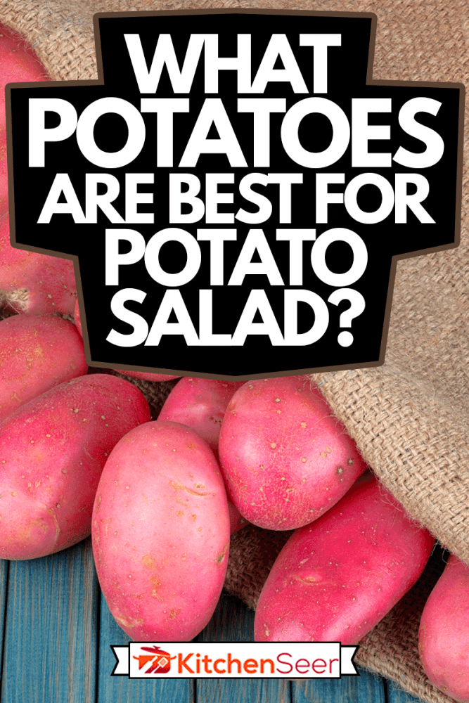 红色粗麻袋土豆在蓝色的木桌上,土豆沙拉土豆是最好的什么?