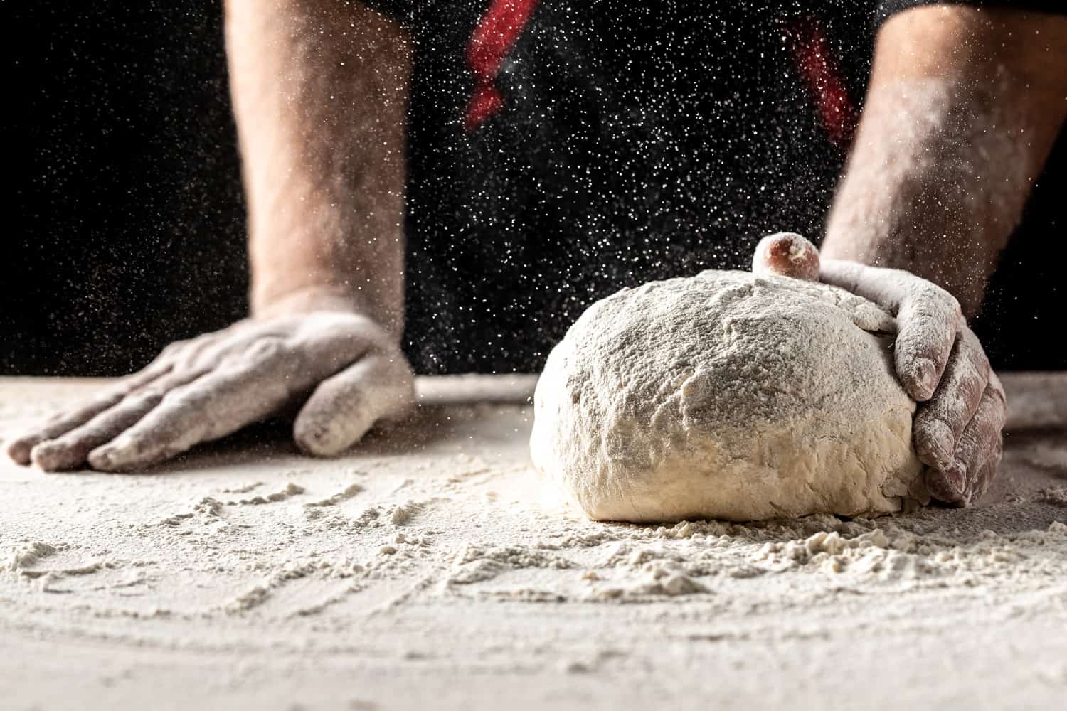 Kneading the Dough. yeast dough for bread or pizza on a floured surface.