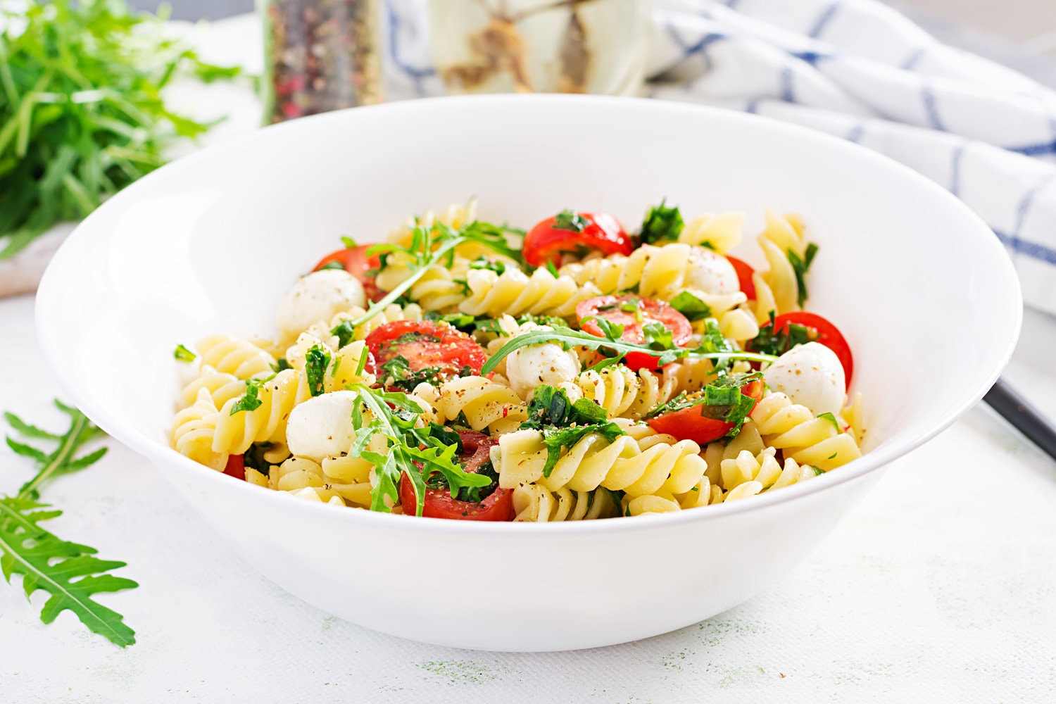 Pasta salad. Fusilli Pasta - Caprese salad with tomato, mozzarella and basil.