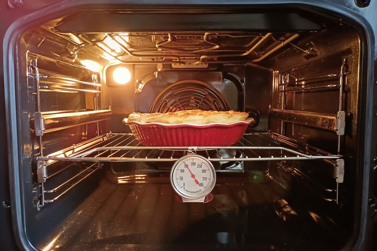 蛋糕在烤箱里烤，温度计显示温度＂width=
